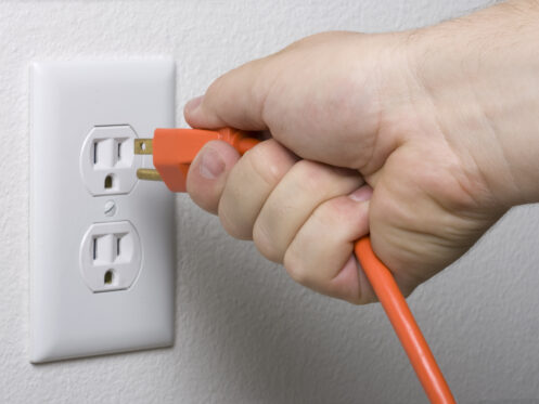 Unplugging a power cord from an outlet